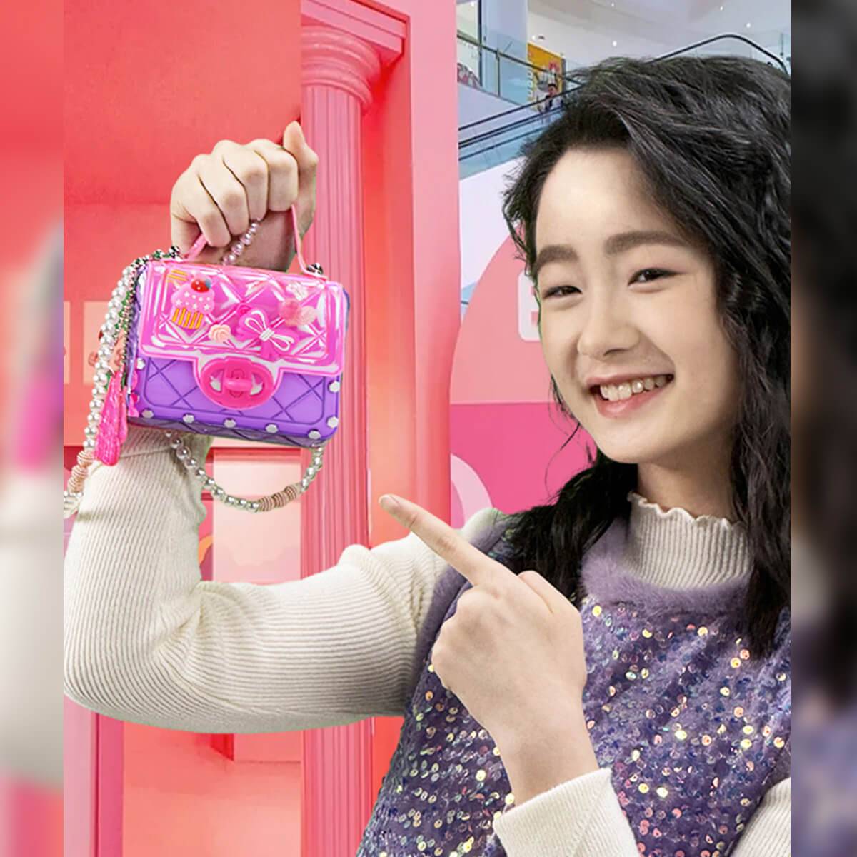 Smiling girl holding a colorful DIY mini bag from the Girls Toy DIY Mini Bag Making Kit. Create stylish handbags with this fun craft set.