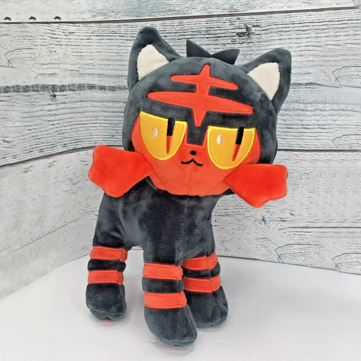 Pokemon Stuffed Plush Toys Litten 23cm featuring soft black and red fabric with embroidered details. A perfect collectible plush for Pokemon fans.