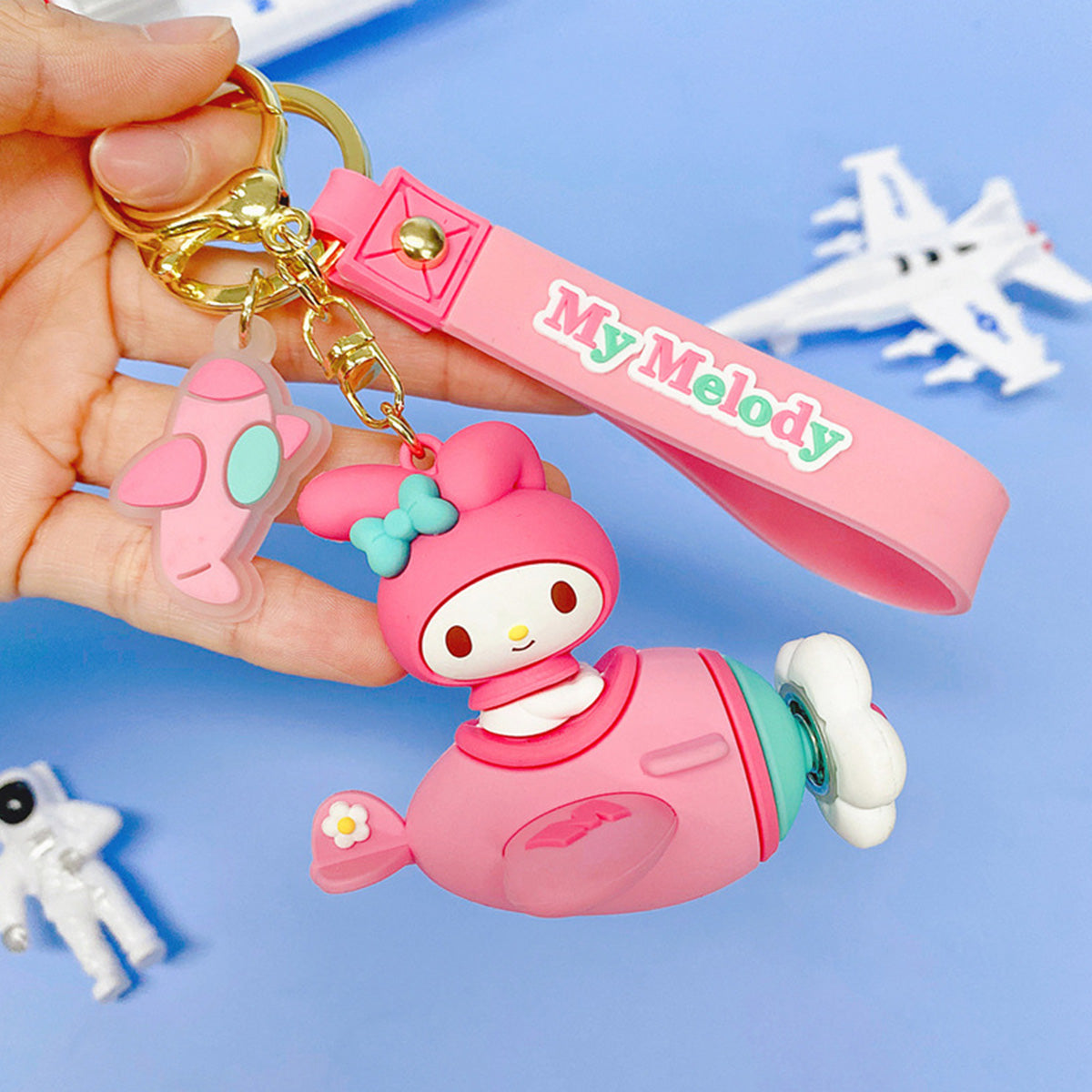 Sanrio Characters in Airplane Keychain featuring My Melody in a pink airplane with a matching wrist strap. A charming accessory for Sanrio lovers.