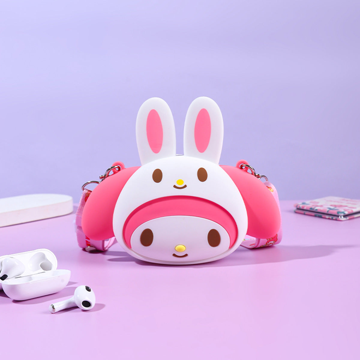 Sanrio Characters Mini Silicone Crossbody Bag featuring a pink My Melody design with bunny ears. A cute and durable accessory for Sanrio fans.