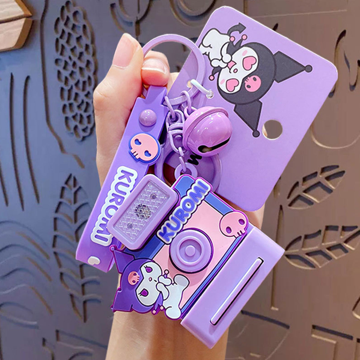 Kuromi-themed Sanrio Characters Polaroid Camera Keychain in purple with a playful design, bell charm, and wrist strap. A must-have for Kuromi lovers.