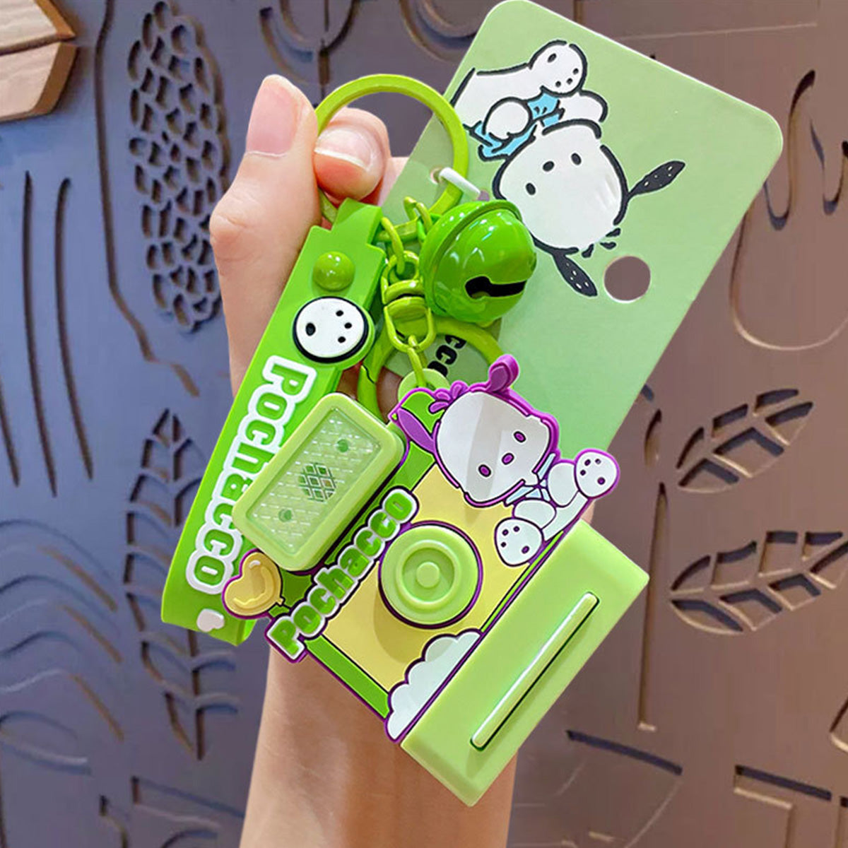 Pochacco-themed Sanrio Characters Polaroid Camera Keychain in green featuring an adorable design, bell charm, and wrist strap. Ideal for Sanrio fans.