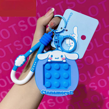 Cinnamoroll Pop It Fidget Keychain in blue with a matching carabiner clip. A cute and functional Sanrio accessory for stress relief and fidgeting.