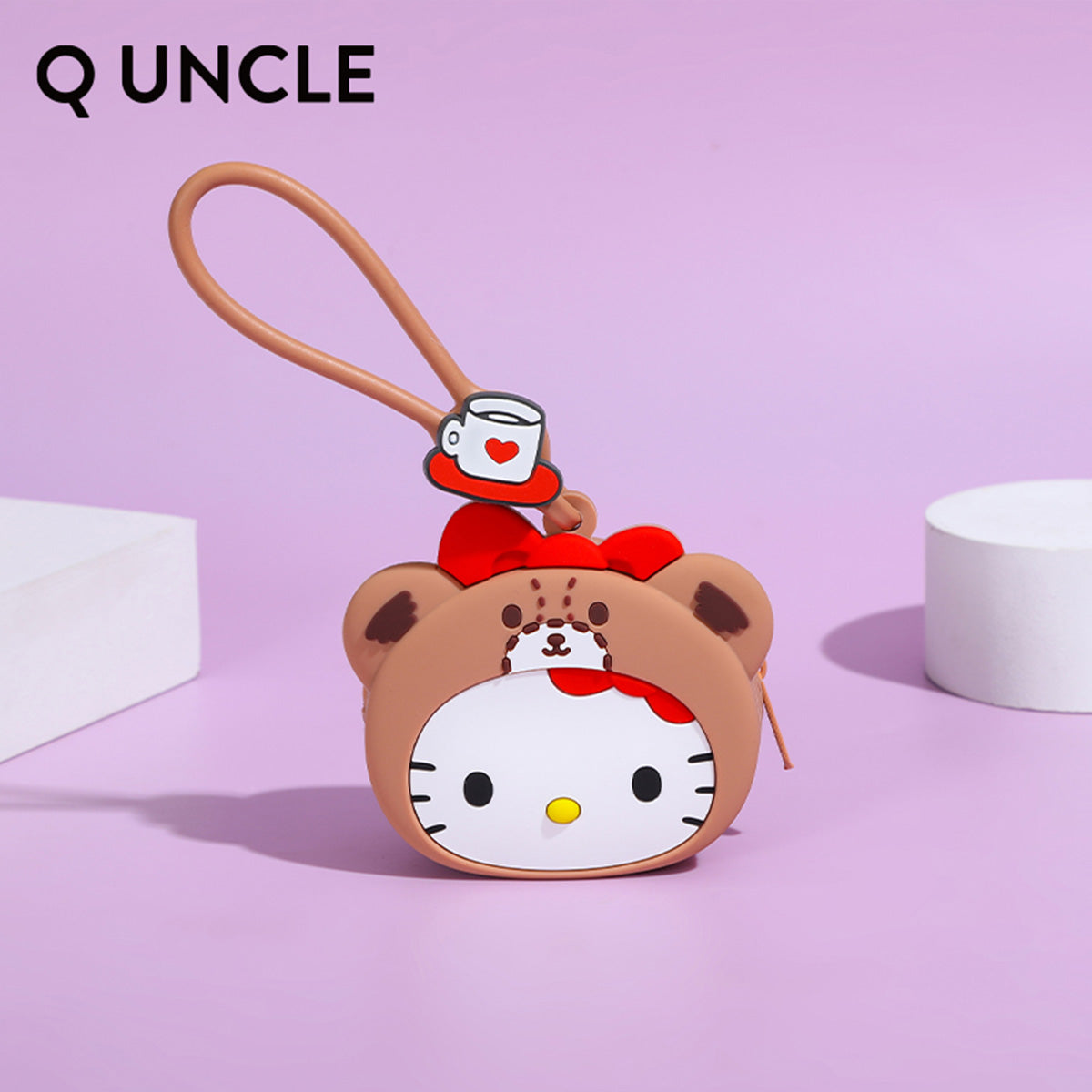 Hello Kitty bear-themed silicone coin purse in brown with a red bow and coffee cup charm. A charming gift for Sanrio lovers.