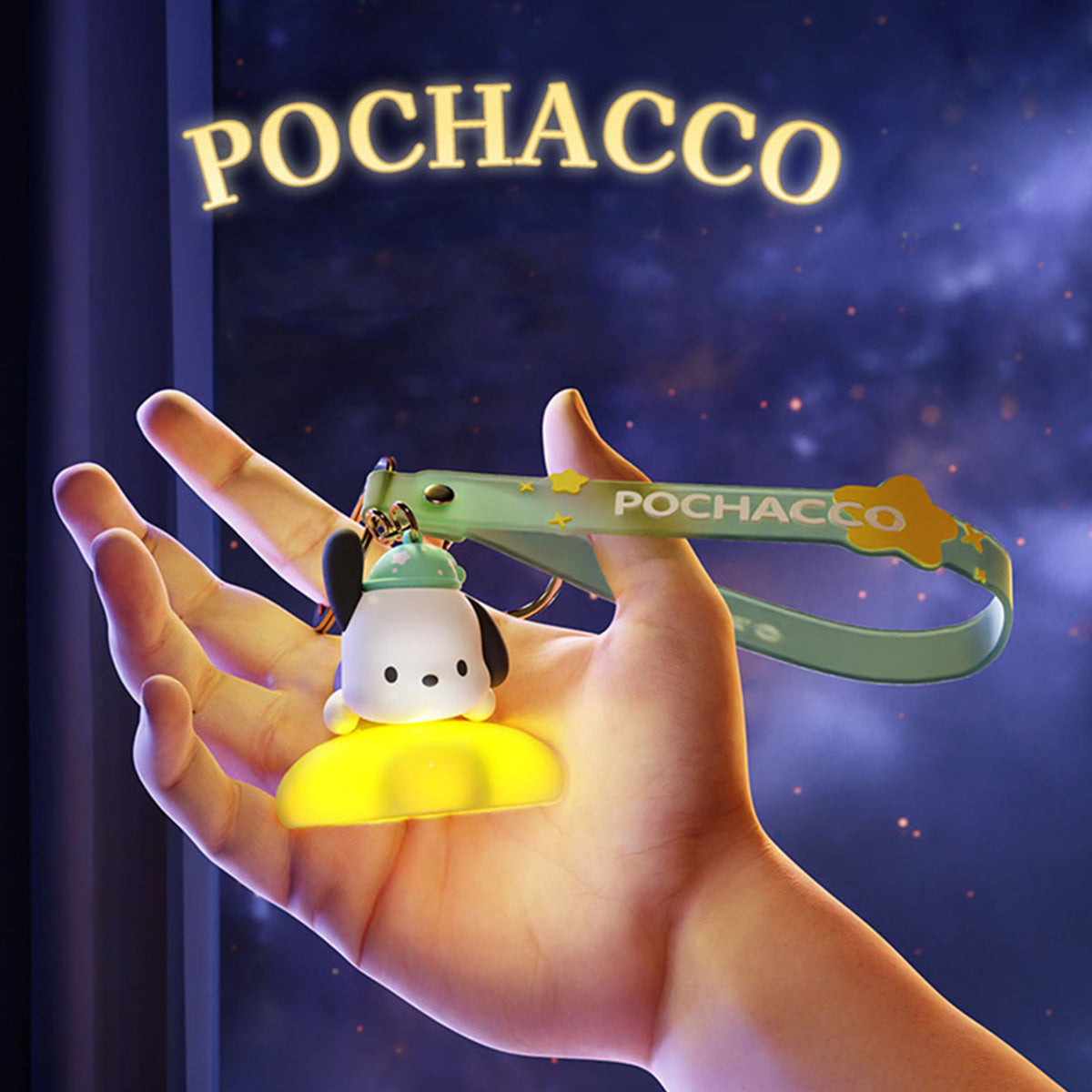 Pochacco Sanrio Family Star Night Light Series Pendant Keychain with glowing yellow base and green strap, held in hand against a starry background.