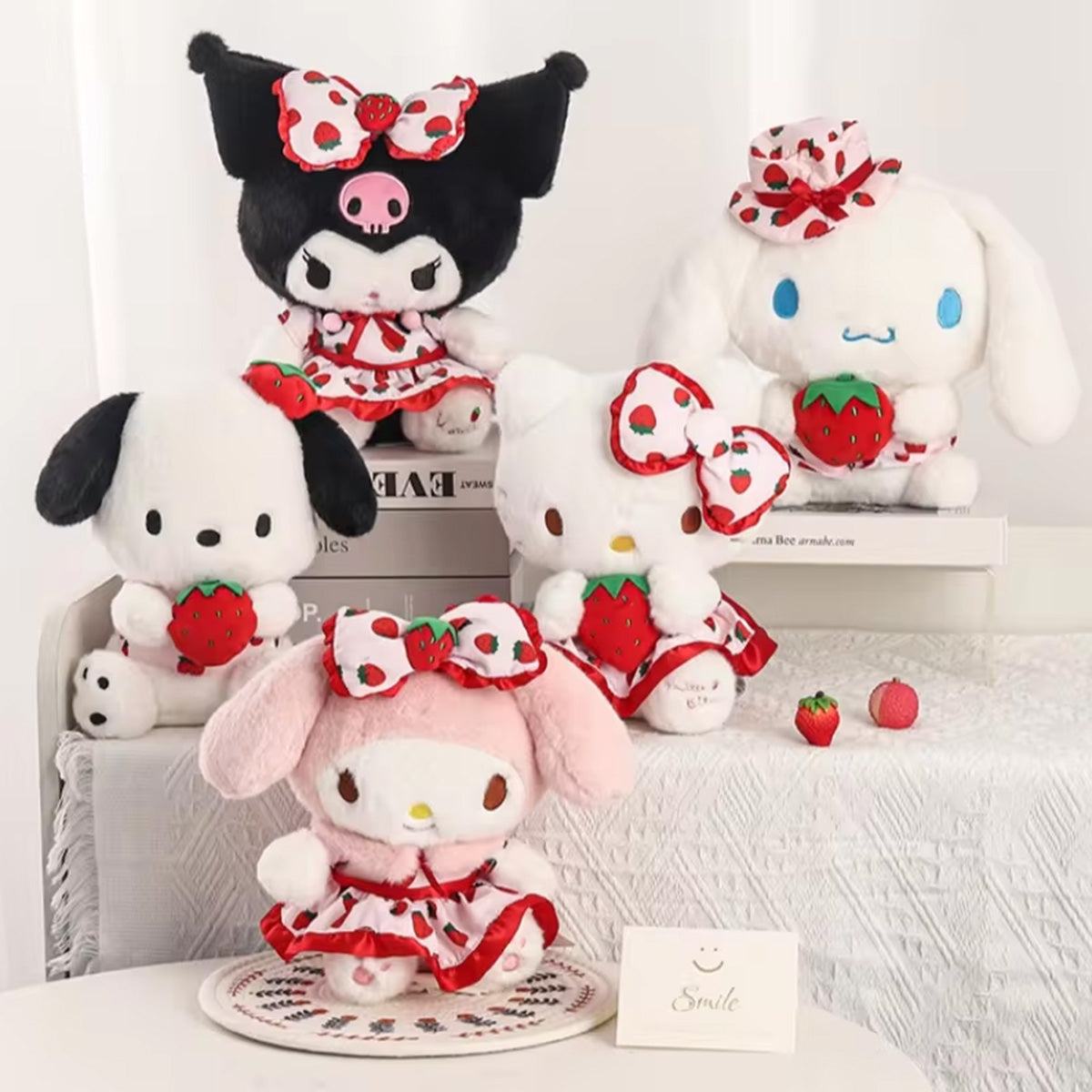 Sanrio Fresh Strawberry Series Plush Keychain 12cm collection featuring four plush characters in strawberry-themed outfits, arranged on a table with decorative elements.