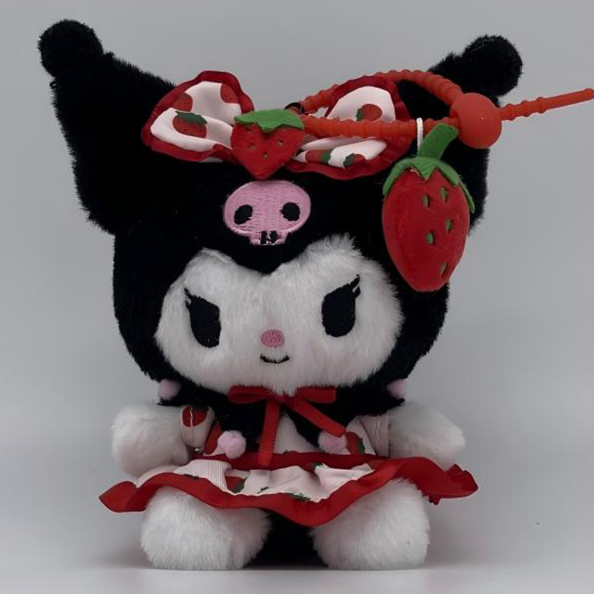 Sanrio Fresh Strawberry Series Plush Keychain 12cm featuring a black and white character with a strawberry-themed bow and dress, attached to a keychain.