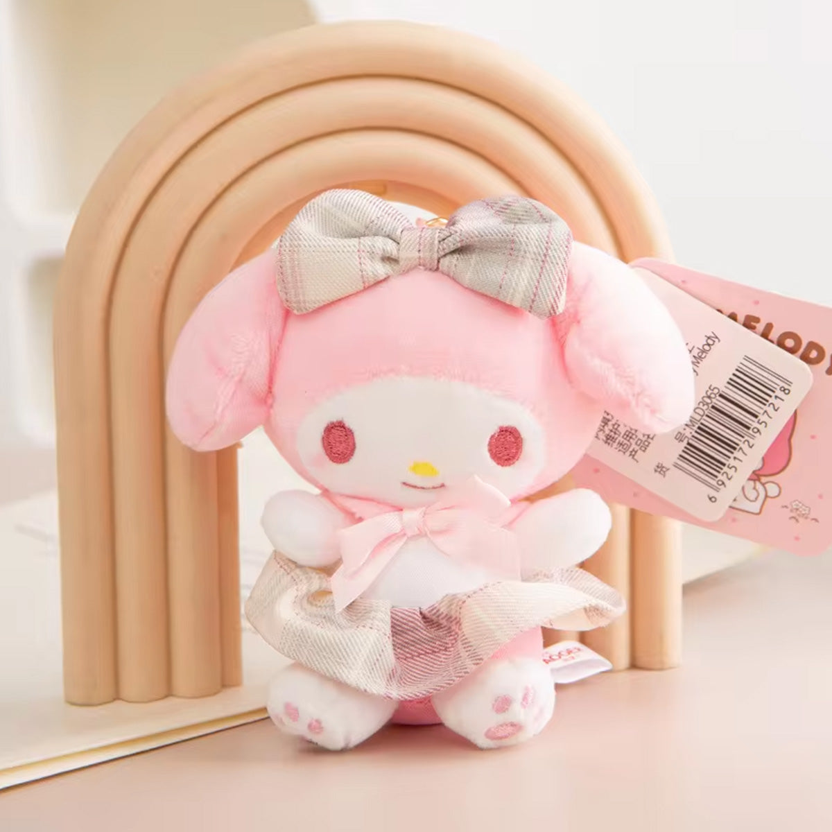 Sanrio JK Series Plush Keychain 10cm featuring My Melody in a pink outfit with a plaid bow and skirt. A charming collectible for bags or keys.