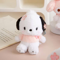 Sanrio Sakura Series Plush Keychain 10cm featuring a white and black puppy character with pink cherry blossom accents. Soft and adorable for bags or keys.