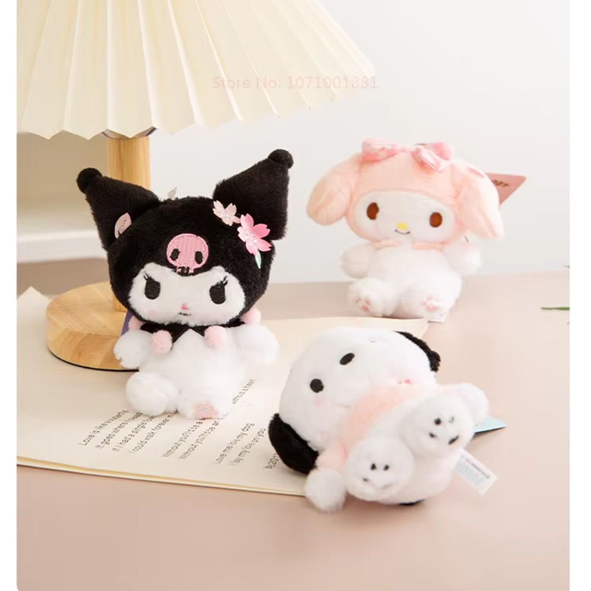 Sanrio Sakura Series Plush Keychain 10cm featuring Kuromi, My Melody, and Pochacco displayed on a table. Soft and charming plush keychains for fans.