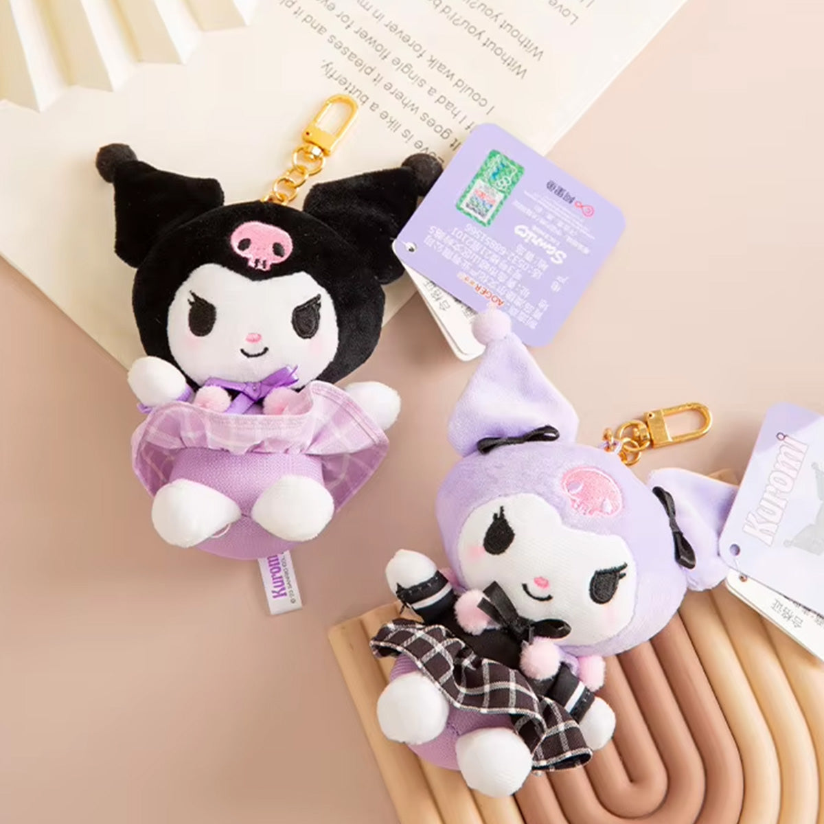 Sanrio Sakura Series Plush Keychain 10cm featuring Kuromi plush keychains in black and purple outfits with cherry blossom details. A stylish collectible set.