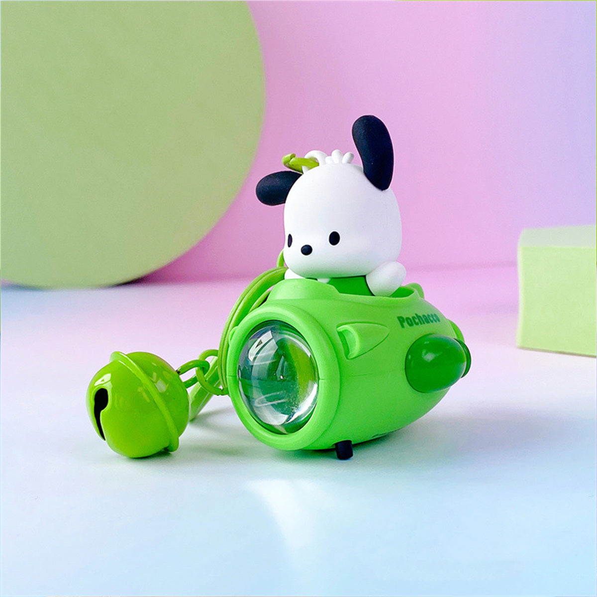 Pochacco Sanrio Sunset Light Spaceship Keychain in green with a glowing light. A charming and functional keychain for fans of Sanrio characters.